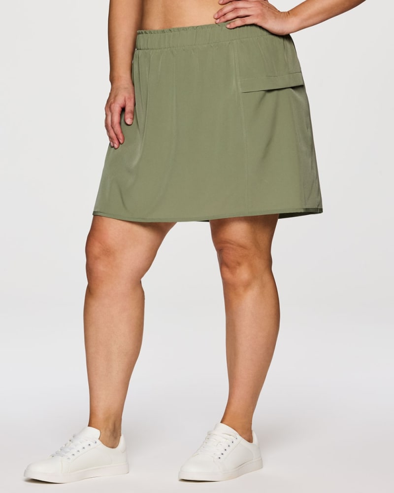 Front of a model wearing a size 3X Plus On Course 19" Skort in Olive by RBX Active. | dia_product_style_image_id:352938